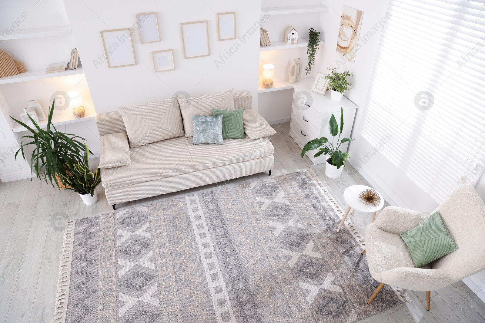 Comfortable sofa and stylish rug in room, above view. Interior design Photo of Comfortable sofa and stylish rug in room, above view. Interior design