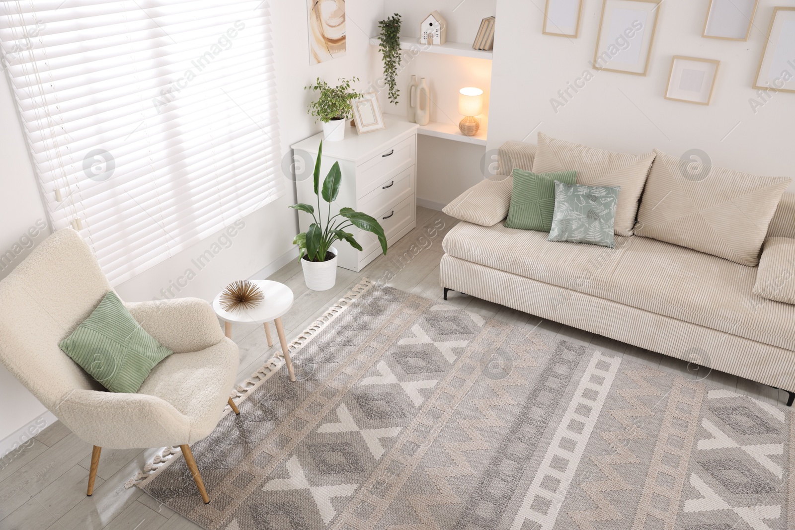 Comfortable sofa and stylish rug in room, above view. Interior design Photo of Comfortable sofa and stylish rug in room, above view. Interior design