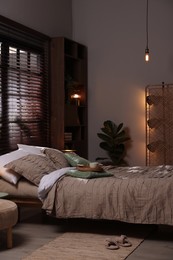 Photo of Comfortable bed with beautiful linens in bedroom