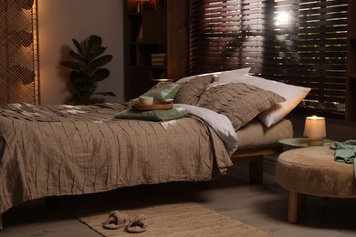 Photo of Comfortable bed with beautiful linens in bedroom