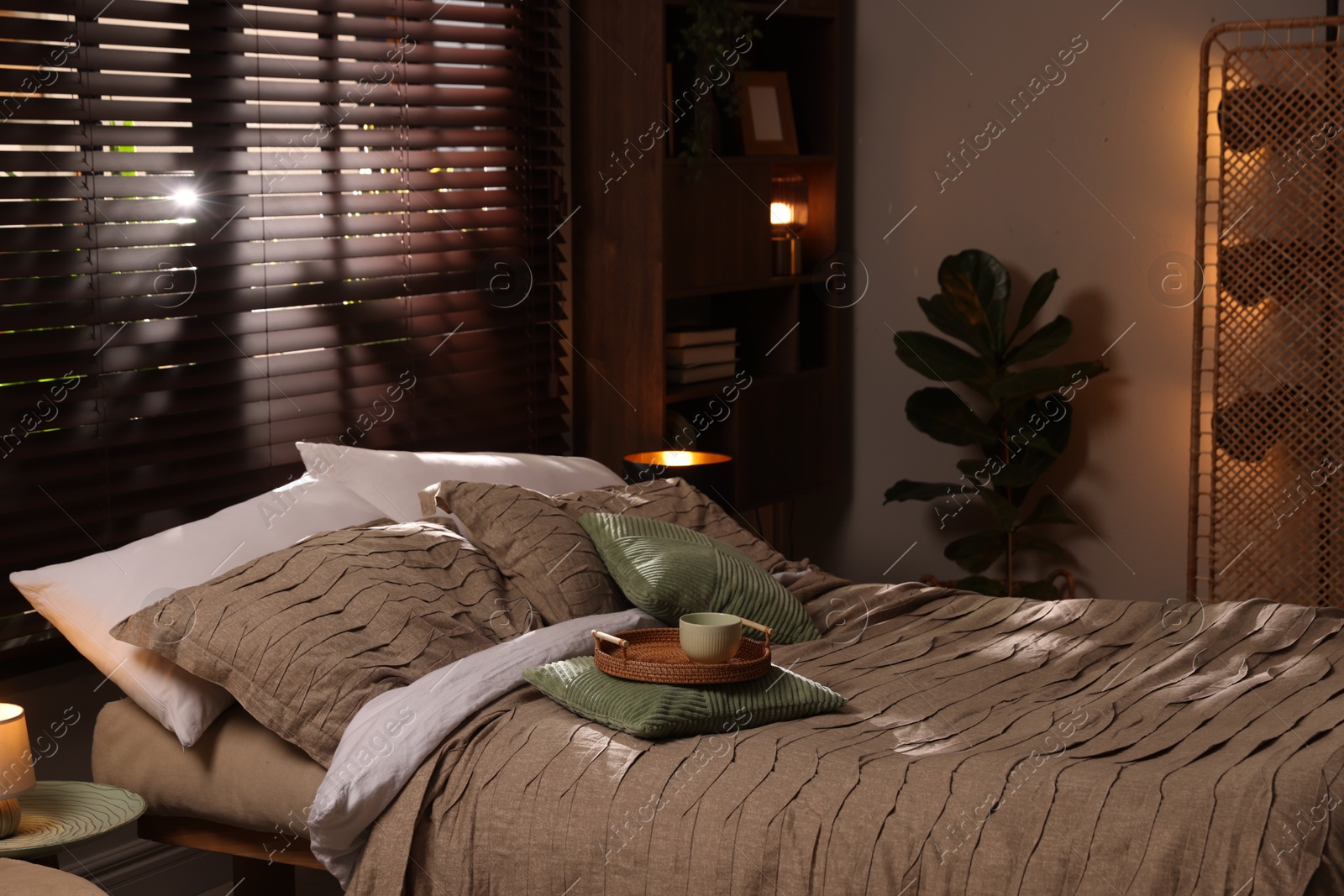 Comfortable bed with beautiful linens in bedroom Photo of Comfortable bed with beautiful linens in bedroom