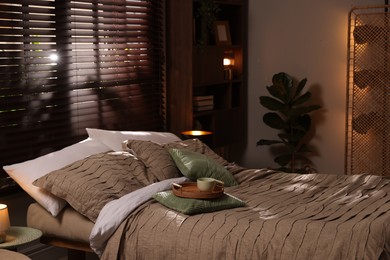 Photo of Comfortable bed with beautiful linens in bedroom