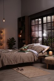 Photo of Comfortable bed with beautiful linens in bedroom