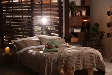 Photo of Comfortable bed with beautiful linens in bedroom
