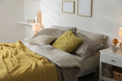 Photo of Comfortable bed with beautiful linens in bedroom