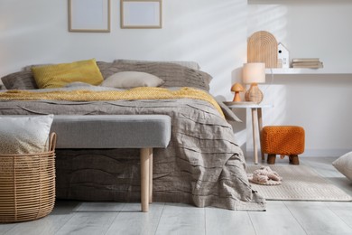 Photo of Comfortable bed with beautiful linens in bedroom