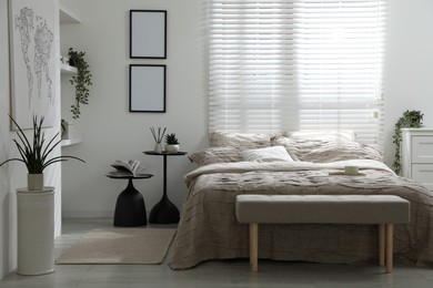 Photo of Comfortable bed with beautiful linens in bedroom