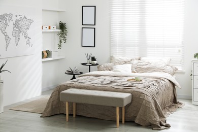 Photo of Comfortable bed with beautiful linens in bedroom