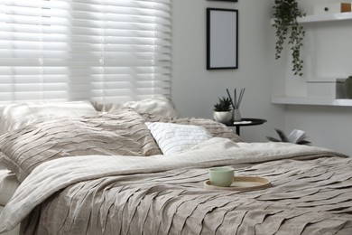 Photo of Comfortable bed with beautiful linens in bedroom