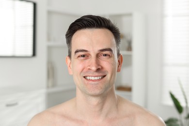 Photo of Portrait of smiling man after shaving at home