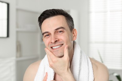 Photo of Portrait of smiling man after shaving at home