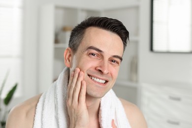 Photo of Portrait of smiling man after shaving at home