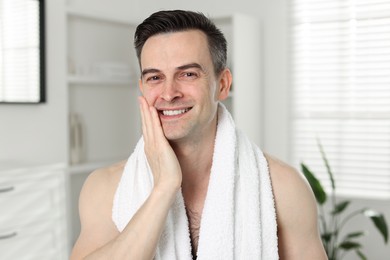 Photo of Portrait of smiling man after shaving at home