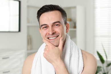 Photo of Portrait of smiling man after shaving at home