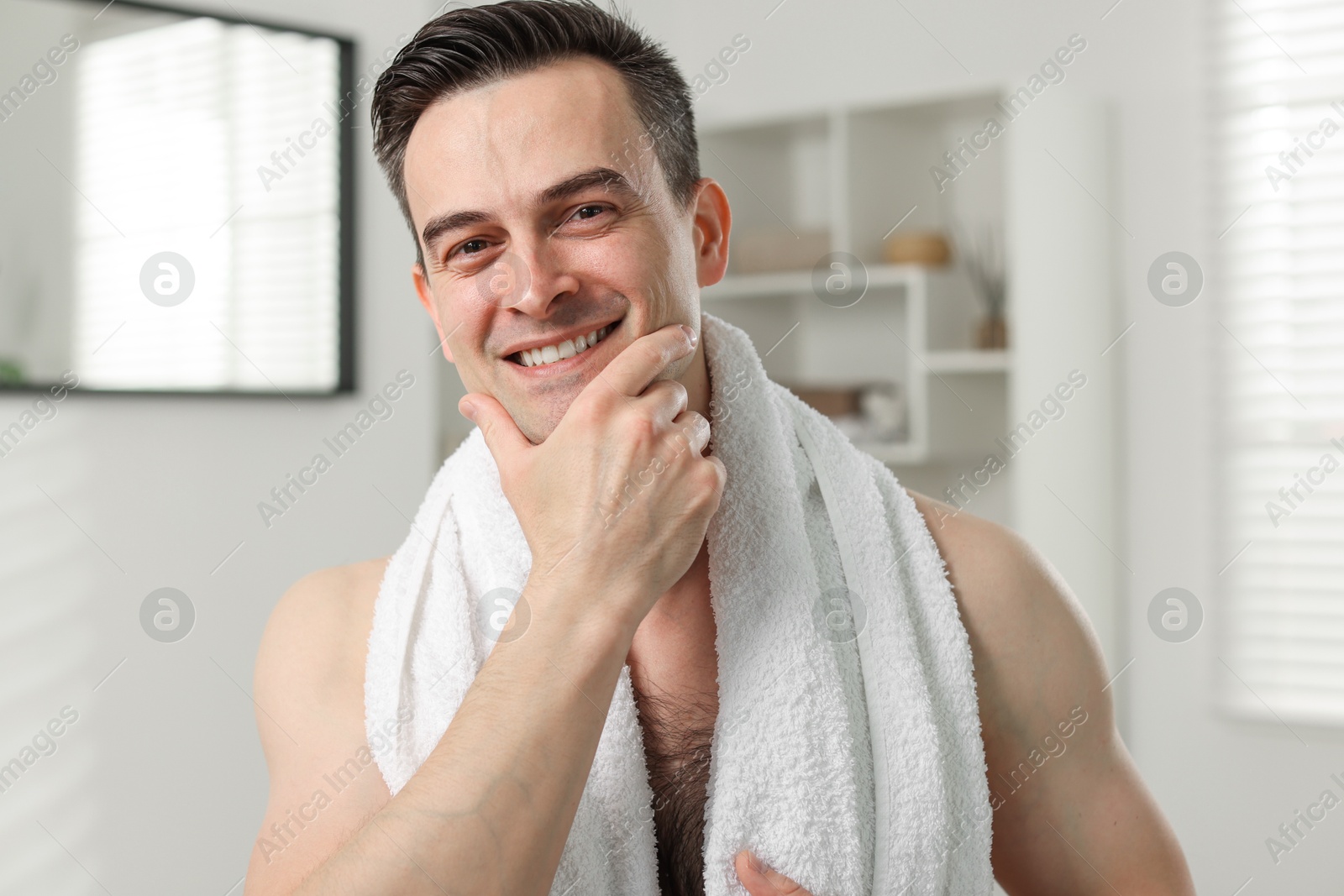 Portrait of smiling man after shaving at home Photo of Portrait of smiling man after shaving at home