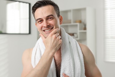 Photo of Portrait of smiling man after shaving at home