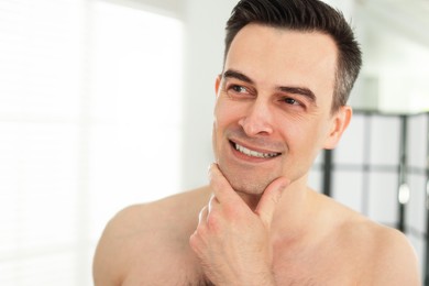 Photo of Smiling man after shaving at home, closeup