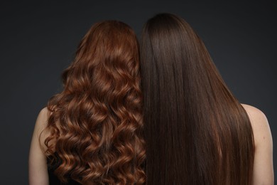 Photo of Teenage girls with healthy long hair on dark grey background, back view