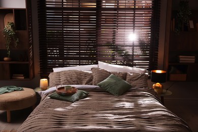 Photo of Comfortable bed with beautiful linens in bedroom