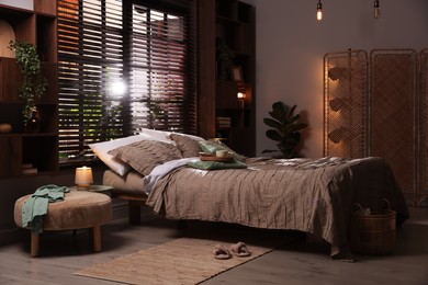 Photo of Comfortable bed with beautiful linens in bedroom