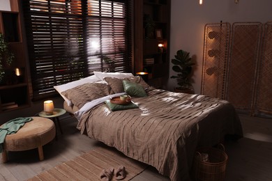 Photo of Comfortable bed with beautiful linens in bedroom