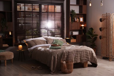 Photo of Comfortable bed with beautiful linens in bedroom