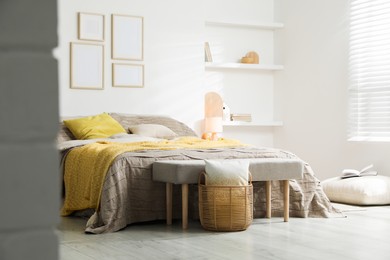 Photo of Comfortable bed with beautiful linens in bedroom