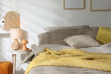 Photo of Comfortable bed with beautiful linens in bedroom