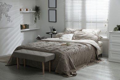 Photo of Comfortable bed with beautiful linens in bedroom