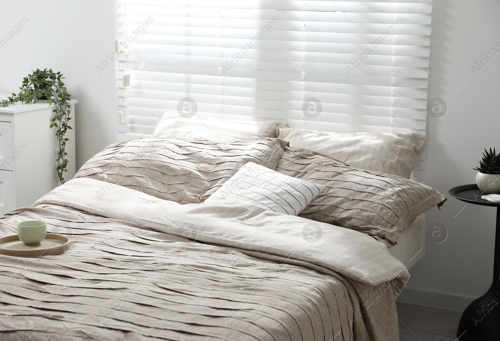 Photo of Comfortable bed with beautiful linens in bedroom