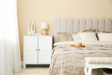 Photo of Comfortable bed with beautiful linens in bedroom