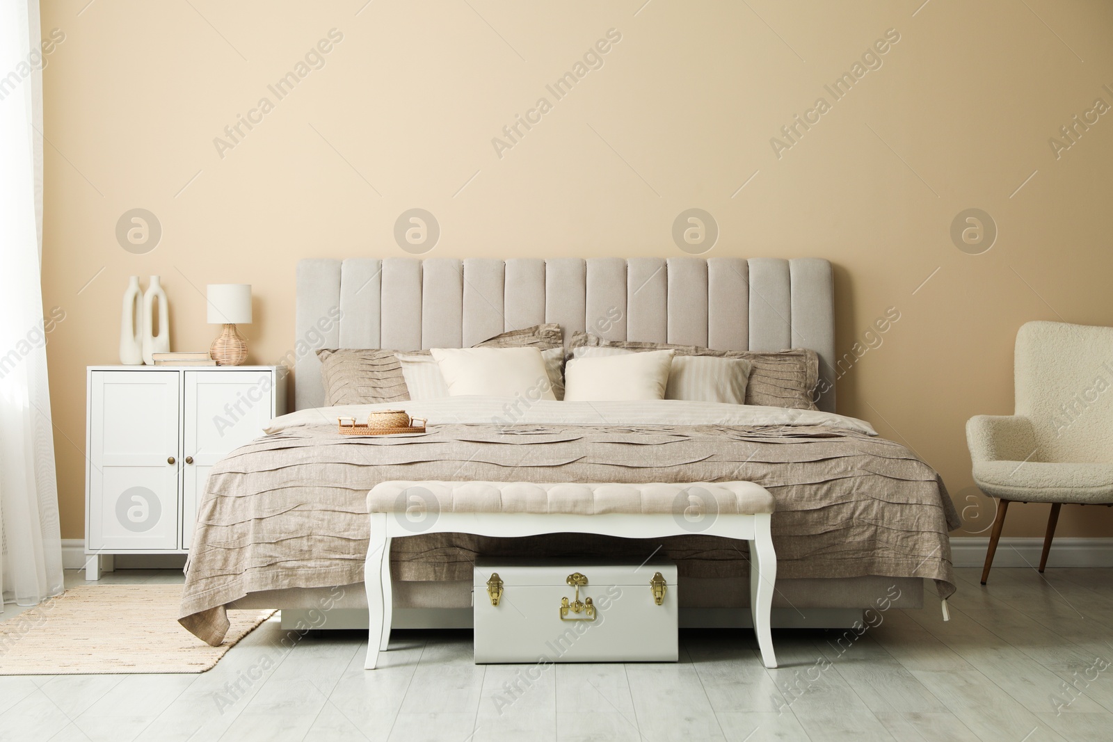 Photo of Comfortable bed with beautiful linens in bedroom