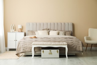 Photo of Comfortable bed with beautiful linens in bedroom