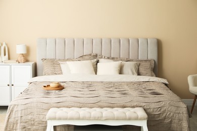 Photo of Comfortable bed with beautiful linens in bedroom