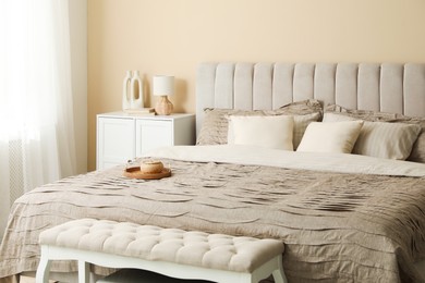 Photo of Comfortable bed with beautiful linens in bedroom