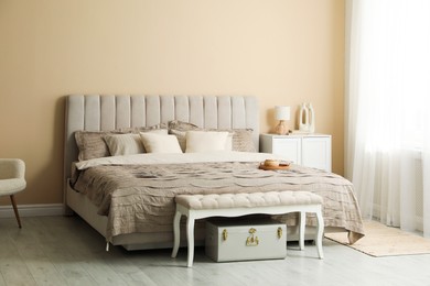 Photo of Comfortable bed with beautiful linens in bedroom