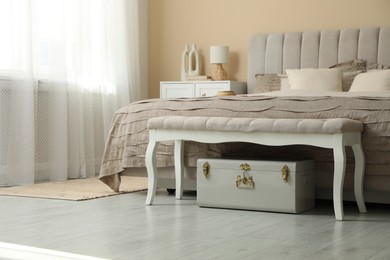 Photo of Comfortable bed with beautiful linens in bedroom