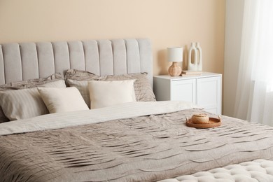 Photo of Comfortable bed with beautiful linens in bedroom