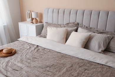 Photo of Comfortable bed with beautiful linens in bedroom