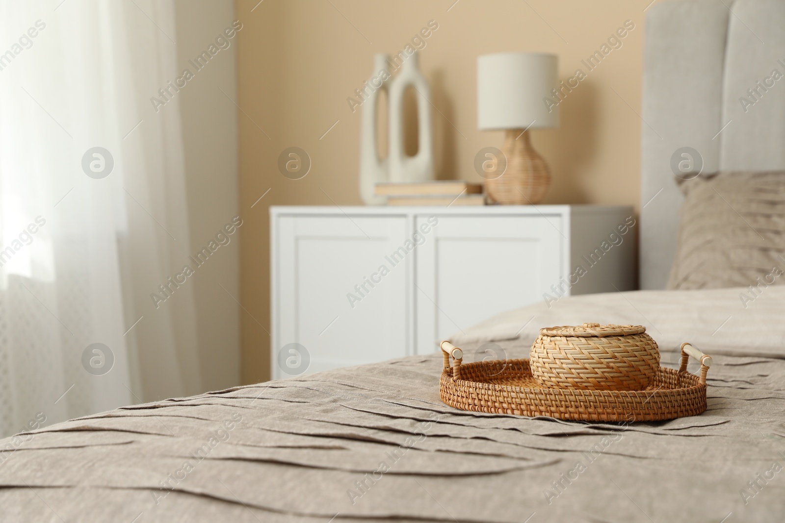 Comfortable bed with beautiful pale brown blanket in bedroom Photo of Comfortable bed with beautiful pale brown blanket in bedroom