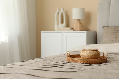 Photo of Comfortable bed with beautiful pale brown blanket in bedroom