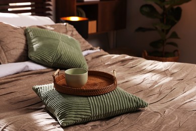 Photo of Comfortable bed with beautiful linens and decor in bedroom