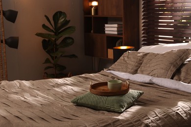 Photo of Comfortable bed with beautiful linens and decor in bedroom