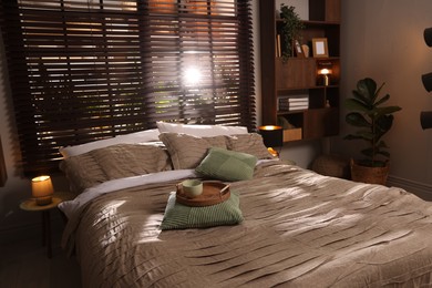 Photo of Comfortable bed with beautiful linens in bedroom