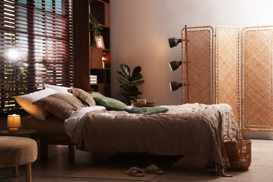 Photo of Comfortable bed with beautiful linens in bedroom