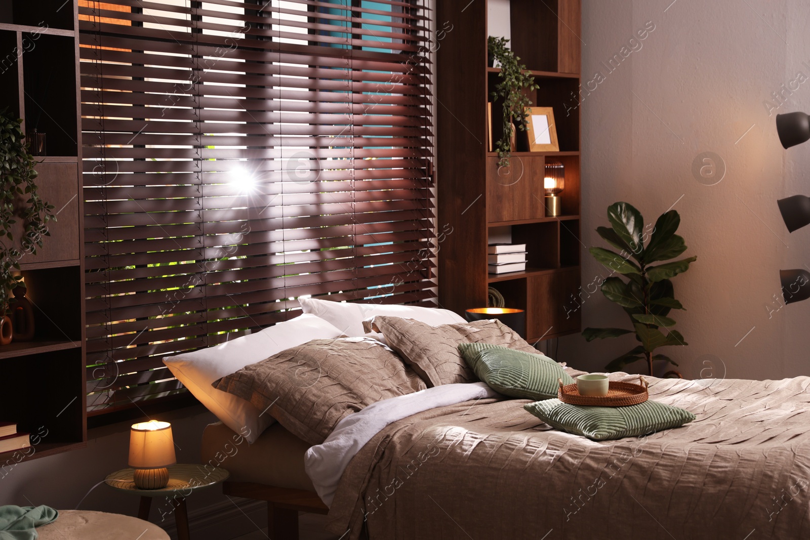 Photo of Comfortable bed with beautiful linens in bedroom