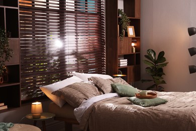 Photo of Comfortable bed with beautiful linens in bedroom