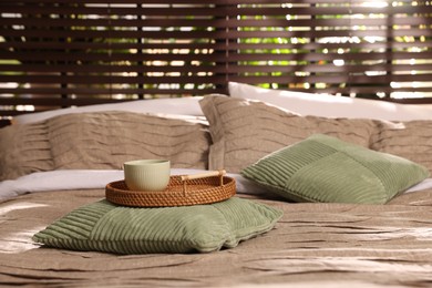 Photo of Comfortable bed with beautiful linens and decor in bedroom