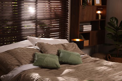 Photo of Comfortable bed with beautiful linens in bedroom