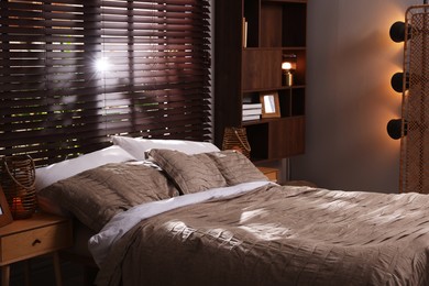 Photo of Comfortable bed with beautiful linens in bedroom